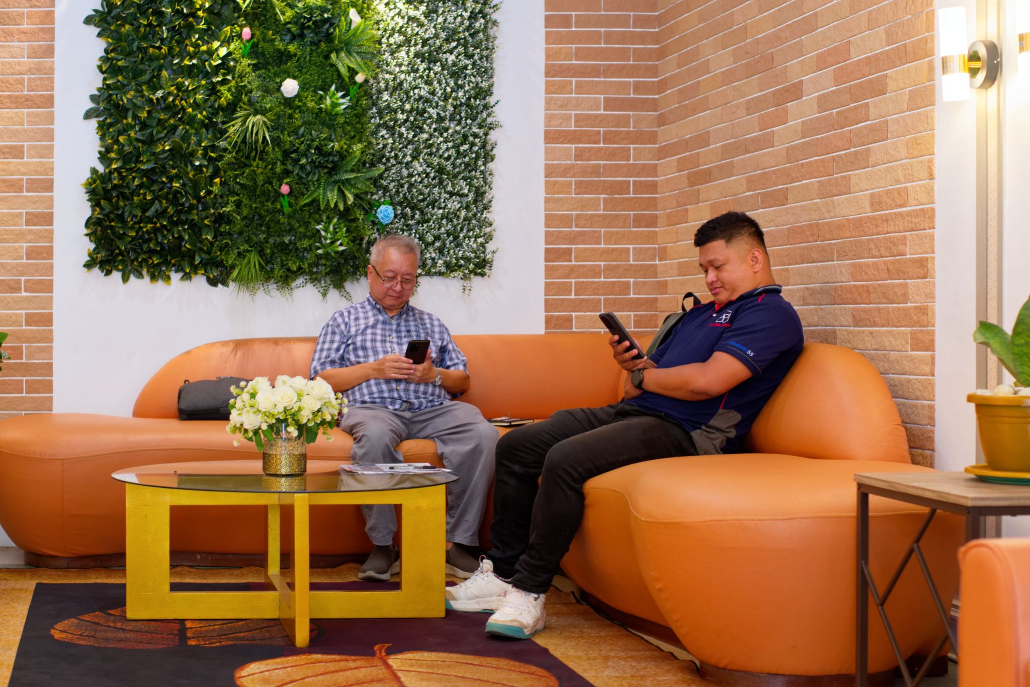 Royal Resort Hotel Lobby seating area brick effect tile green wall panel